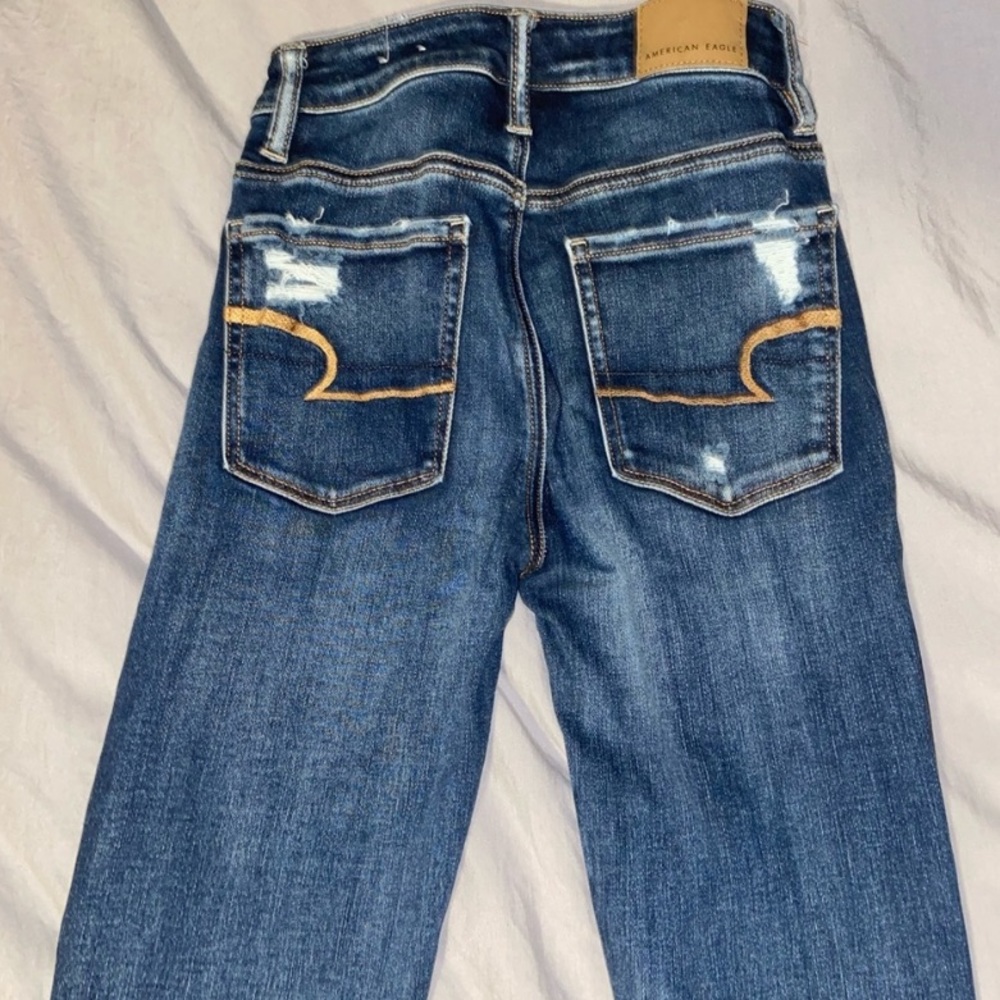 2 pairs of ripped american eagle jeans